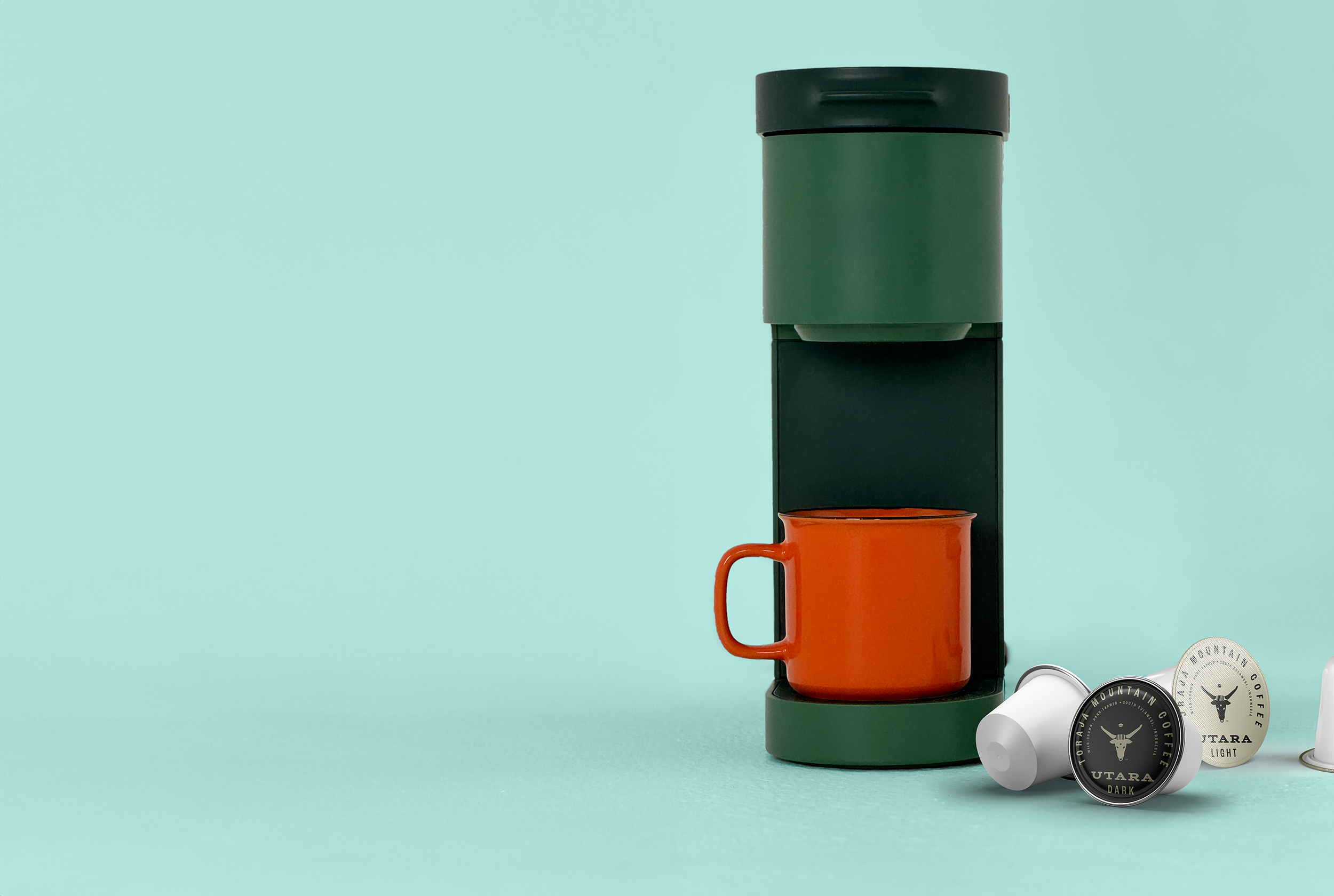 keurig machine with cup of coffee and toraja mountain coffee kcups